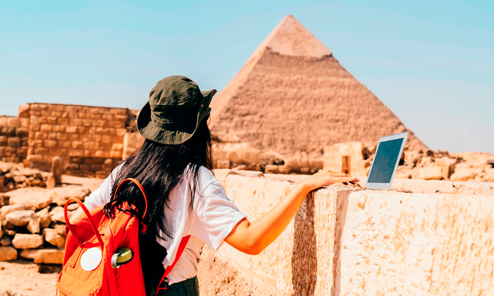 Asian archaeologist works on a pyramid pharaoh research in Giza, Cairo