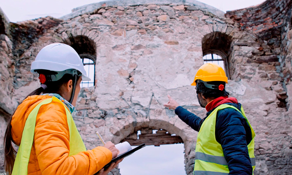 Renovation of the old church. Architect and engineer taking measurements in the field